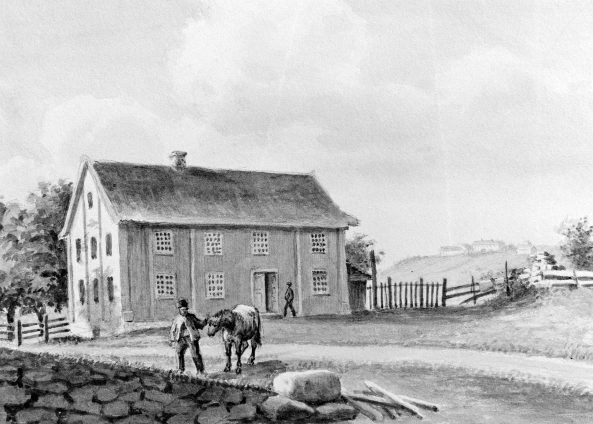 Building in the farmyard, with a man and a horse