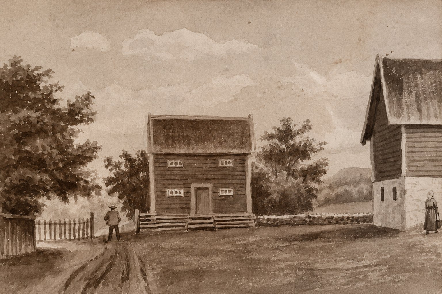 Building in the farmyard, with a man and a woman
