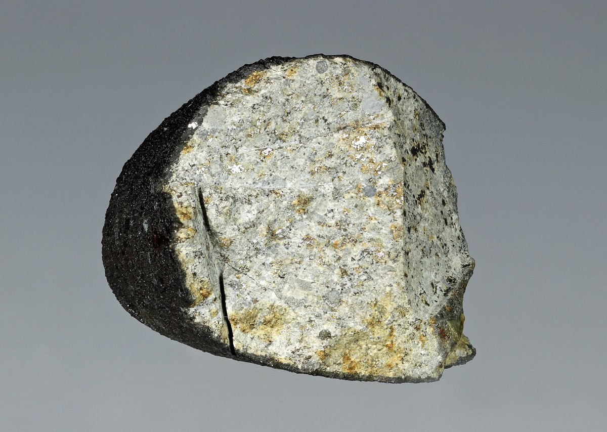 Grefsheim-meteoritten. Den svarte smelteskorpa dannet seg da steinen falt gjennom atmosfæren.